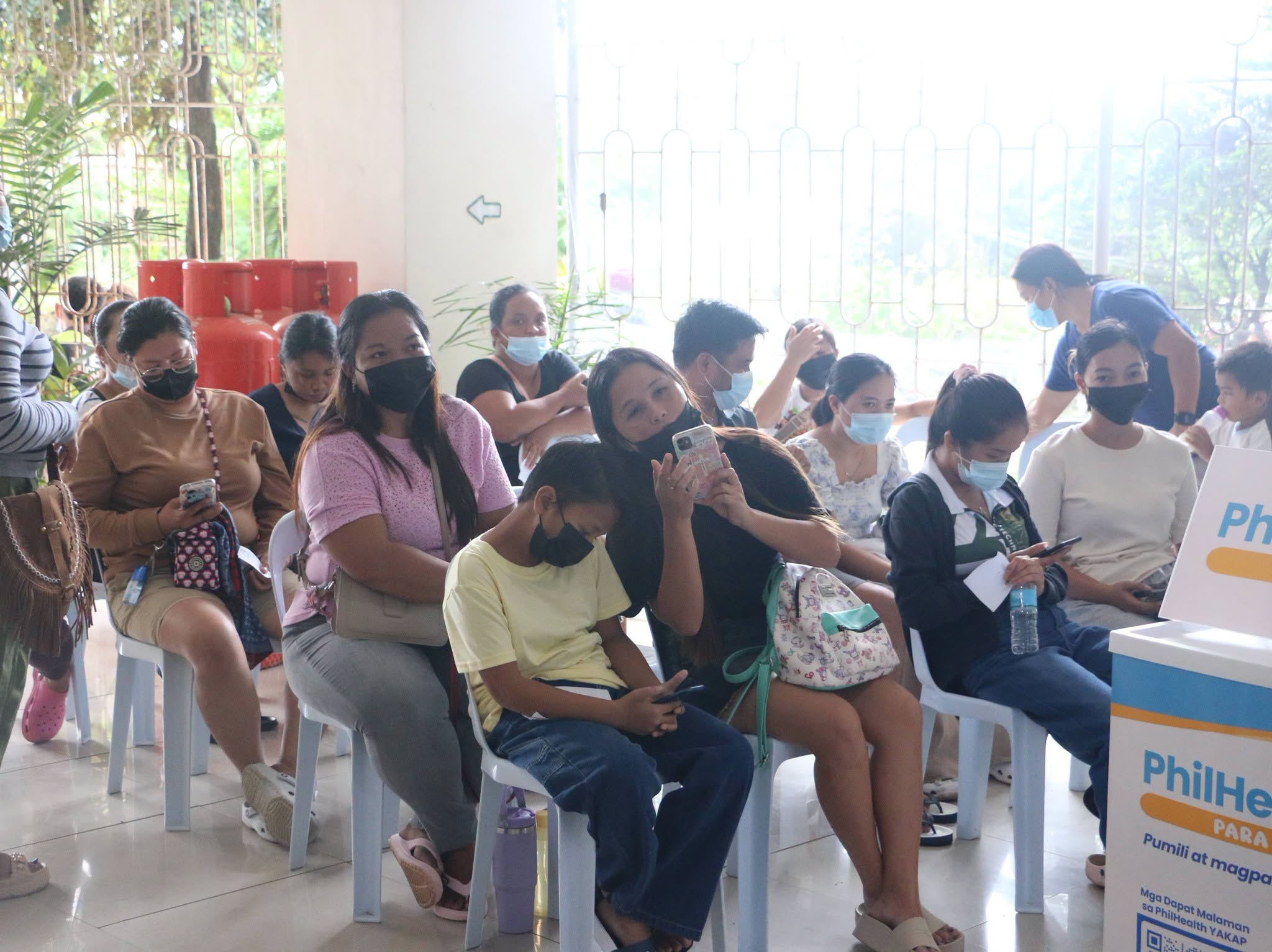Residents line up to register and avail the services offered under PhilHealth’s Yaman ng Kalusugan Program (YAKAP).