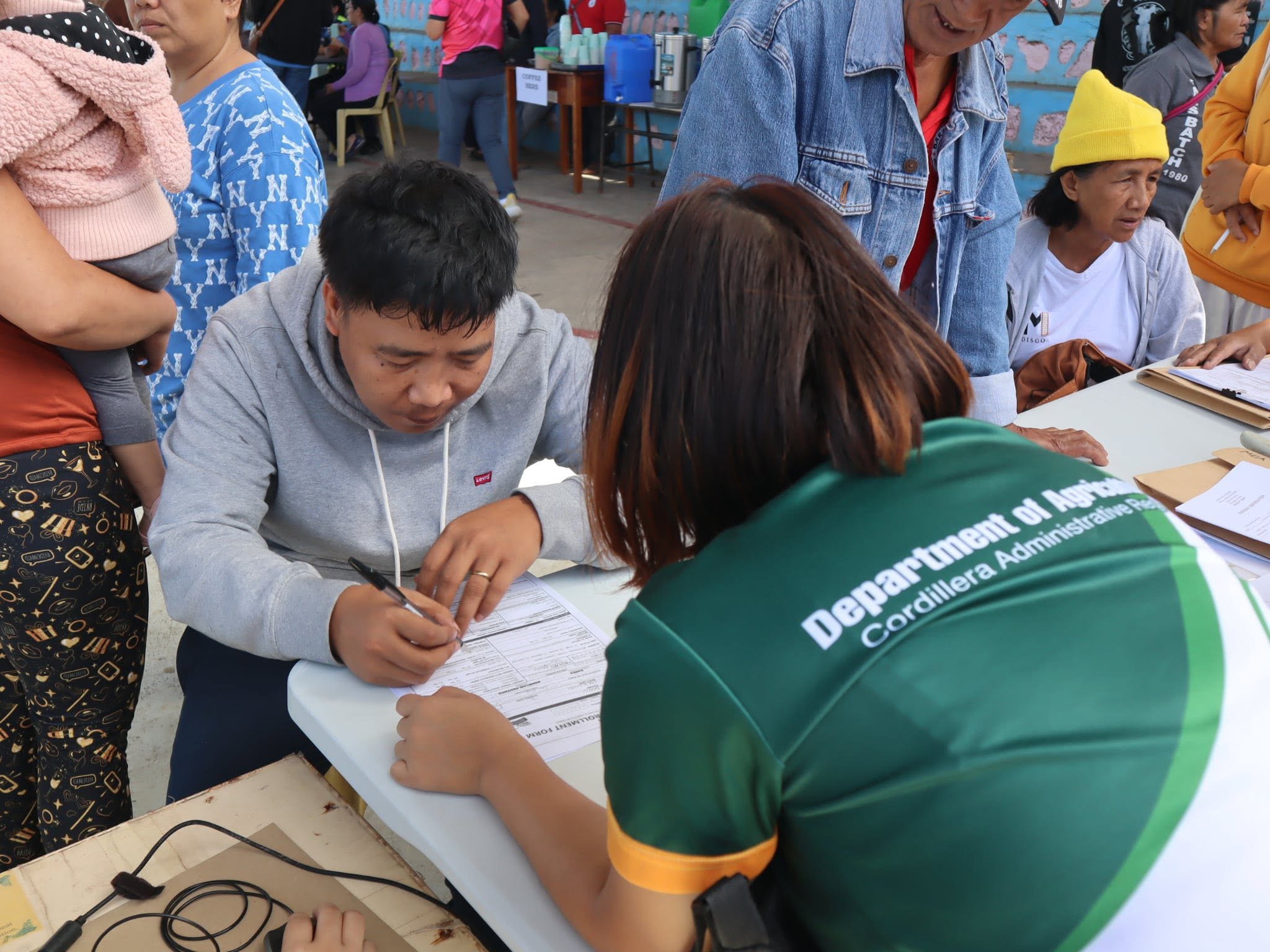Personnel from the Department of Agriculture – Mountain Province assist residents on their services during the Retooled Community Support Program Barangay Consultation and Serbisyo Caravan on June 25, 2026 in Banao, Bauko, Mountain Province.