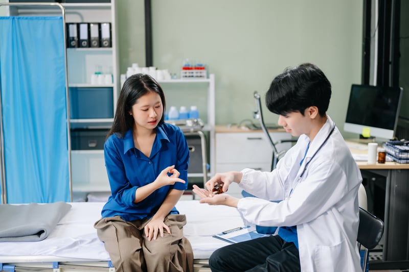 Doctor examining patient with symptoms in a clinic. Medical consultation and healthcare interaction.nuttapong_mohock