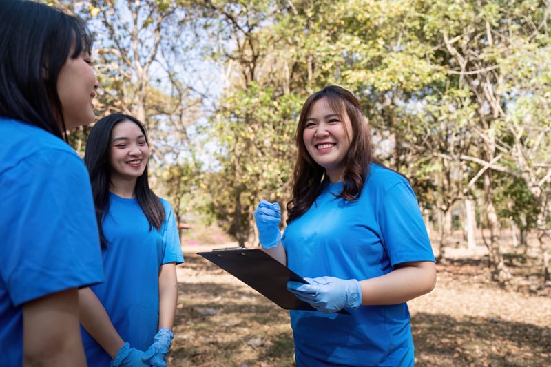 Volunteer collecting plastic trash in the forest. The concept of environmental conservation. Globalnateemee