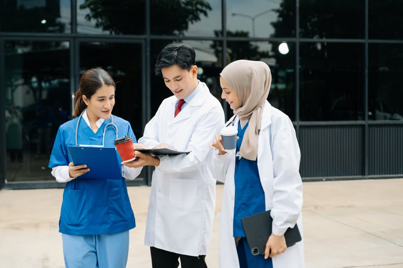 Medical Professionals Collaborating and Drinking Coffee Outdoorsnuttapong_mohock