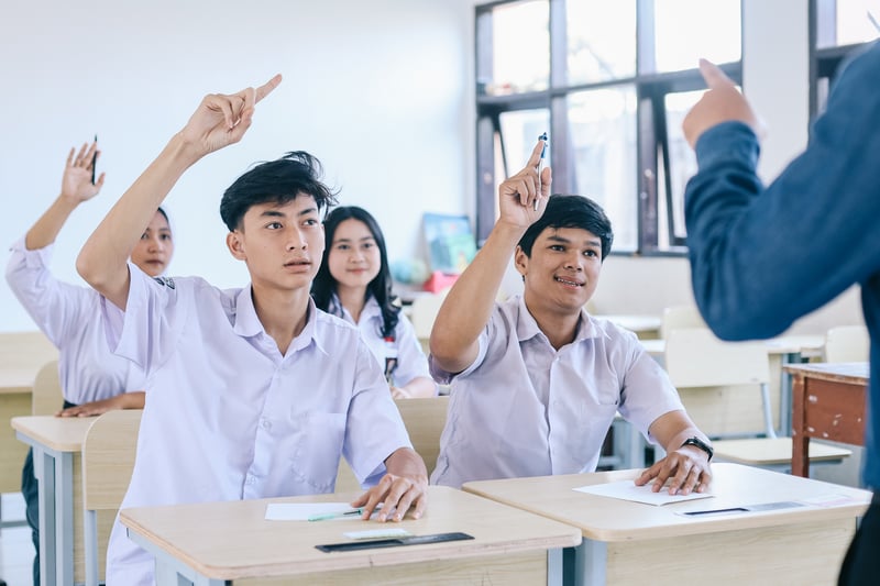 Teenage Students Raising Hands in Classroom with TeacherQueenmoonlite35