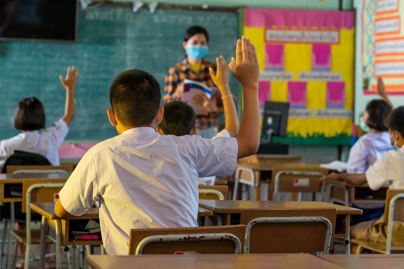 Students Raise Hands in Classroom with Teachervisootu2