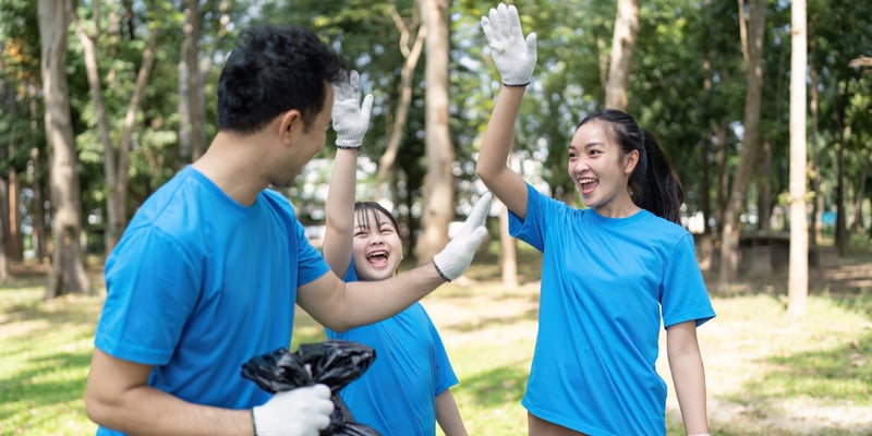 Excited family volunteers celebrating their garbage collection efforts in a parknateemee
