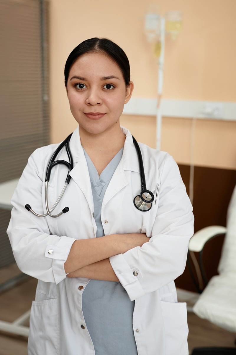 Female Doctor in Hospital Standing with Arms Crossedseventyfourimages