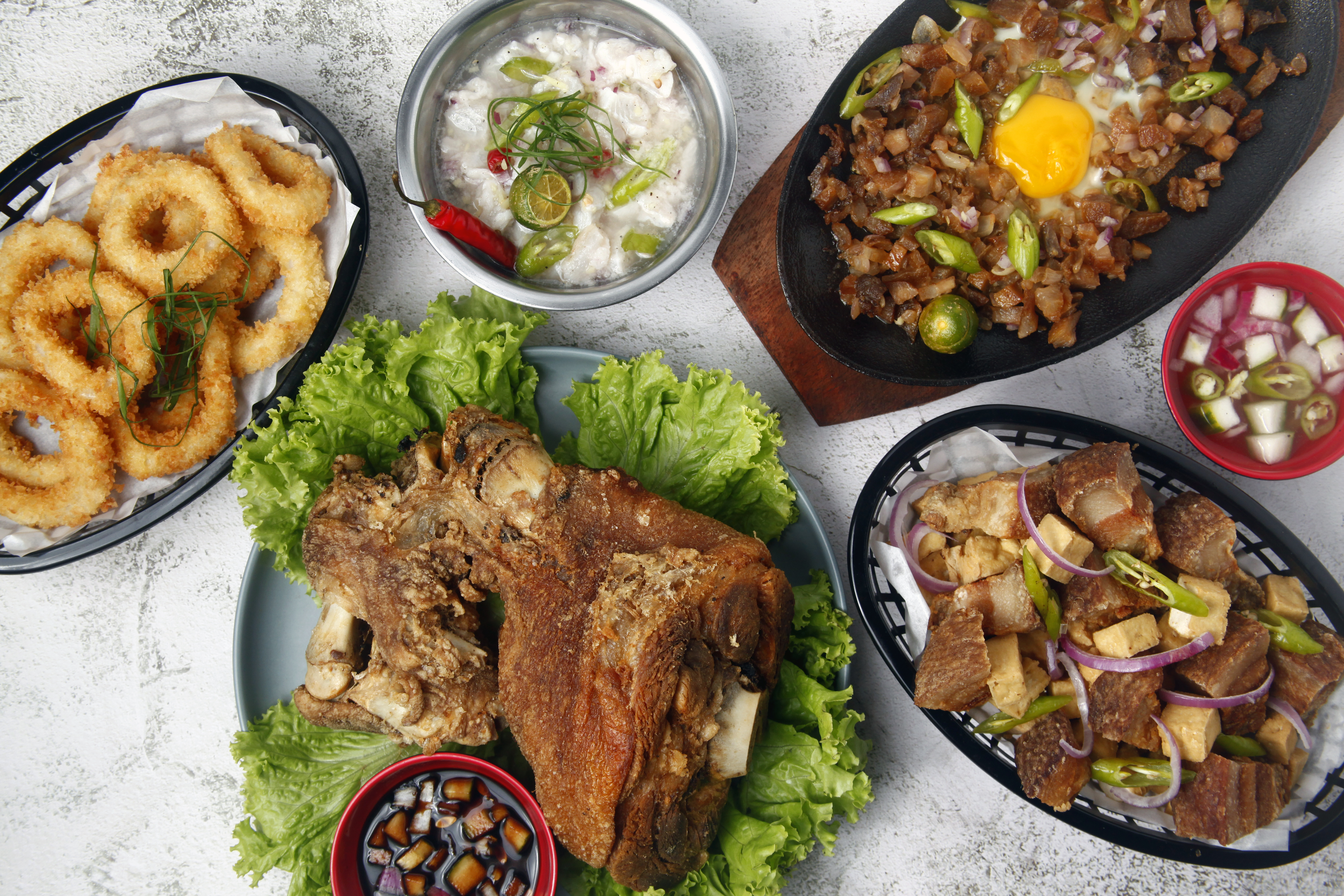 Appetizing Filipino Cuisine Displayed on a White Surface