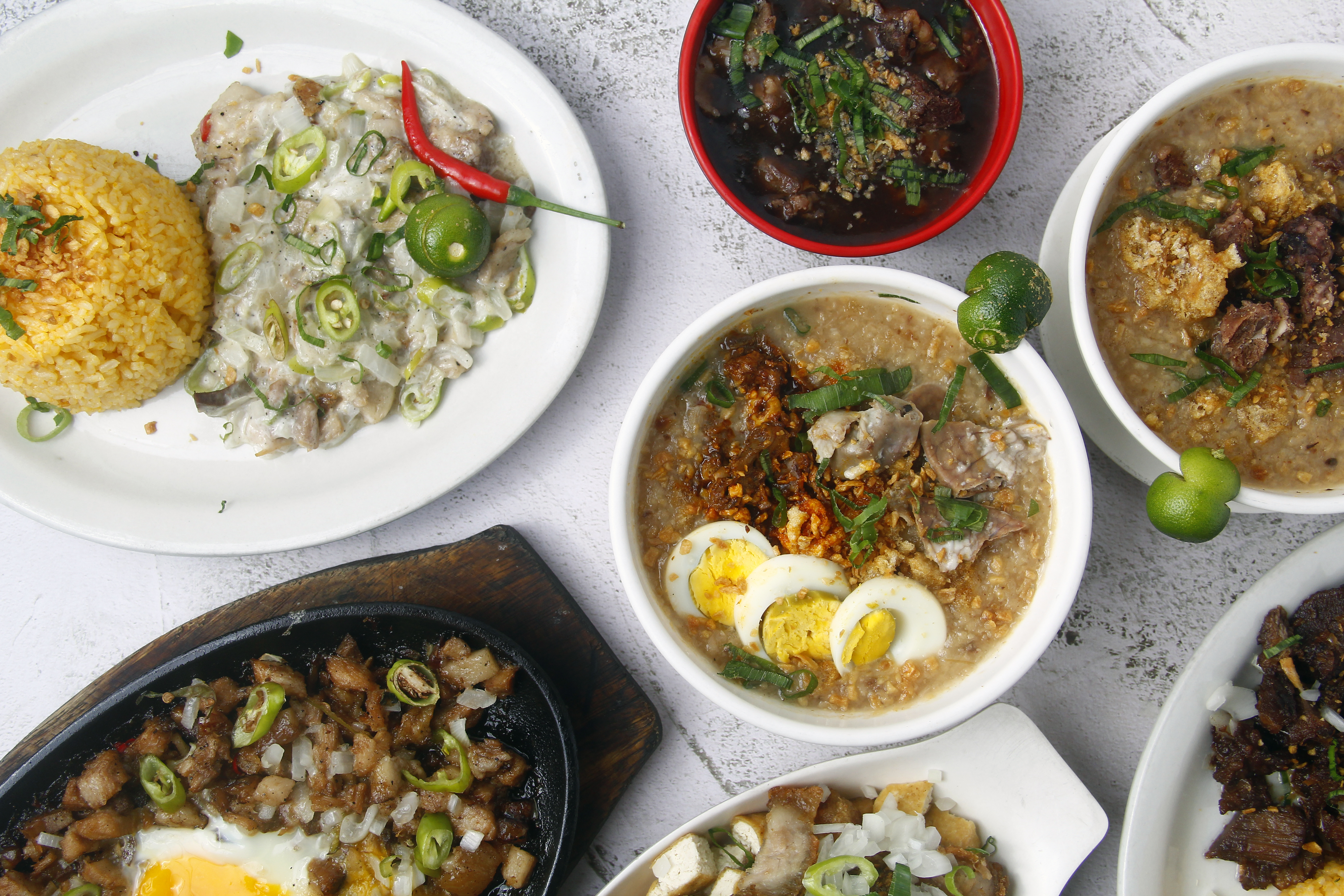 Selection of Filipino Dishes on a White Table