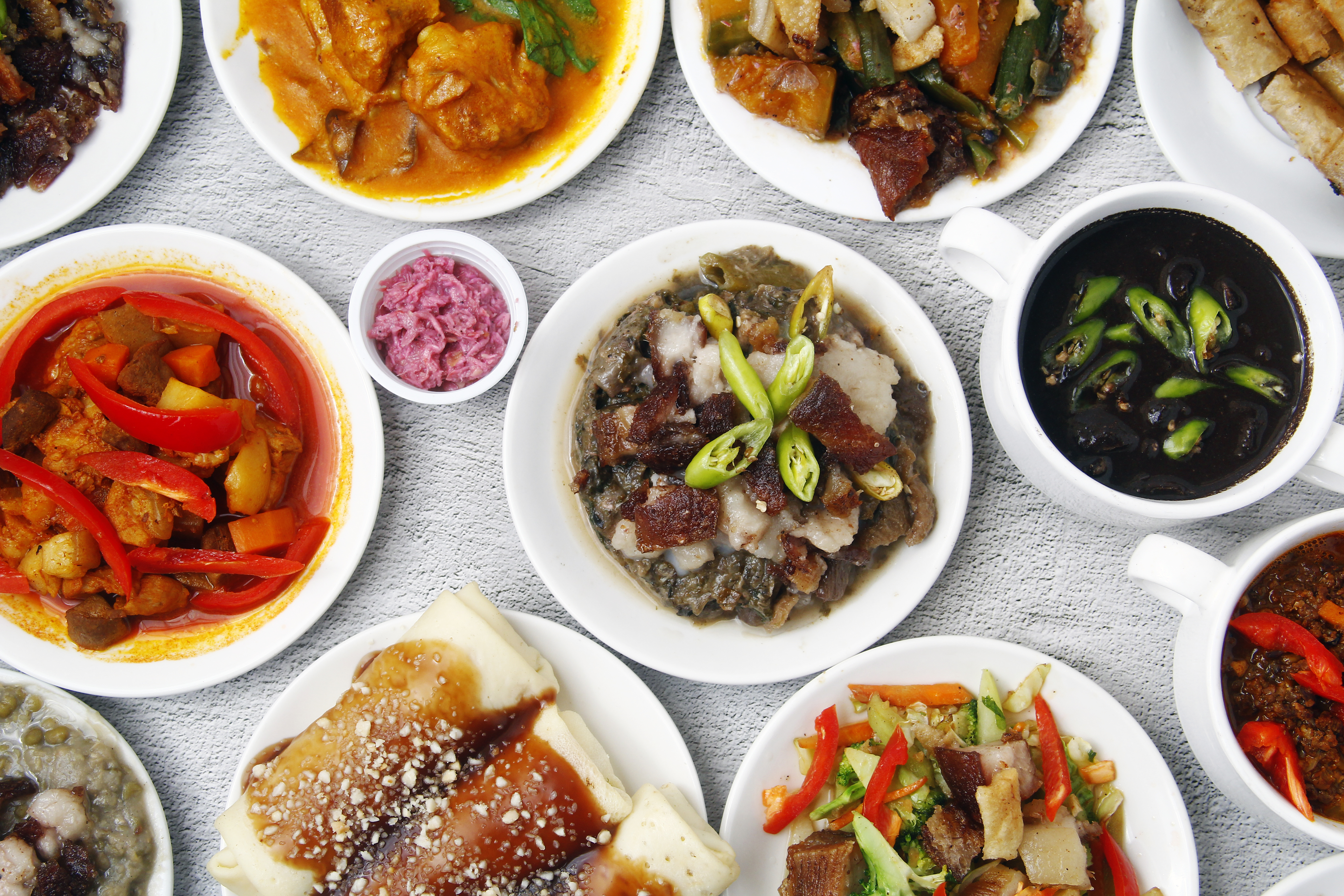 Variety of Colorful Filipino Cuisine on White Plates
