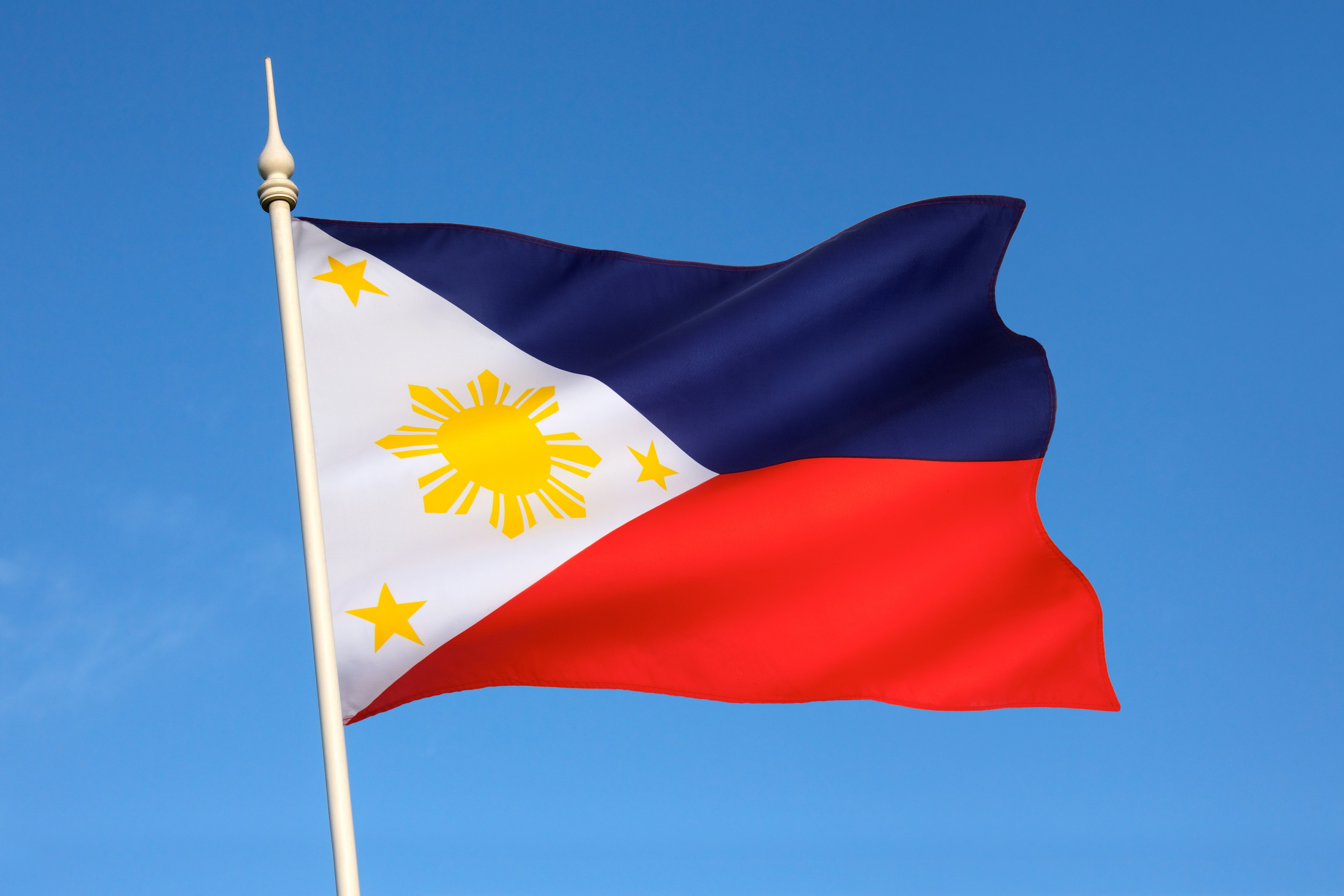 Philippine Flag Against Bright Blue Sky Backdrop
