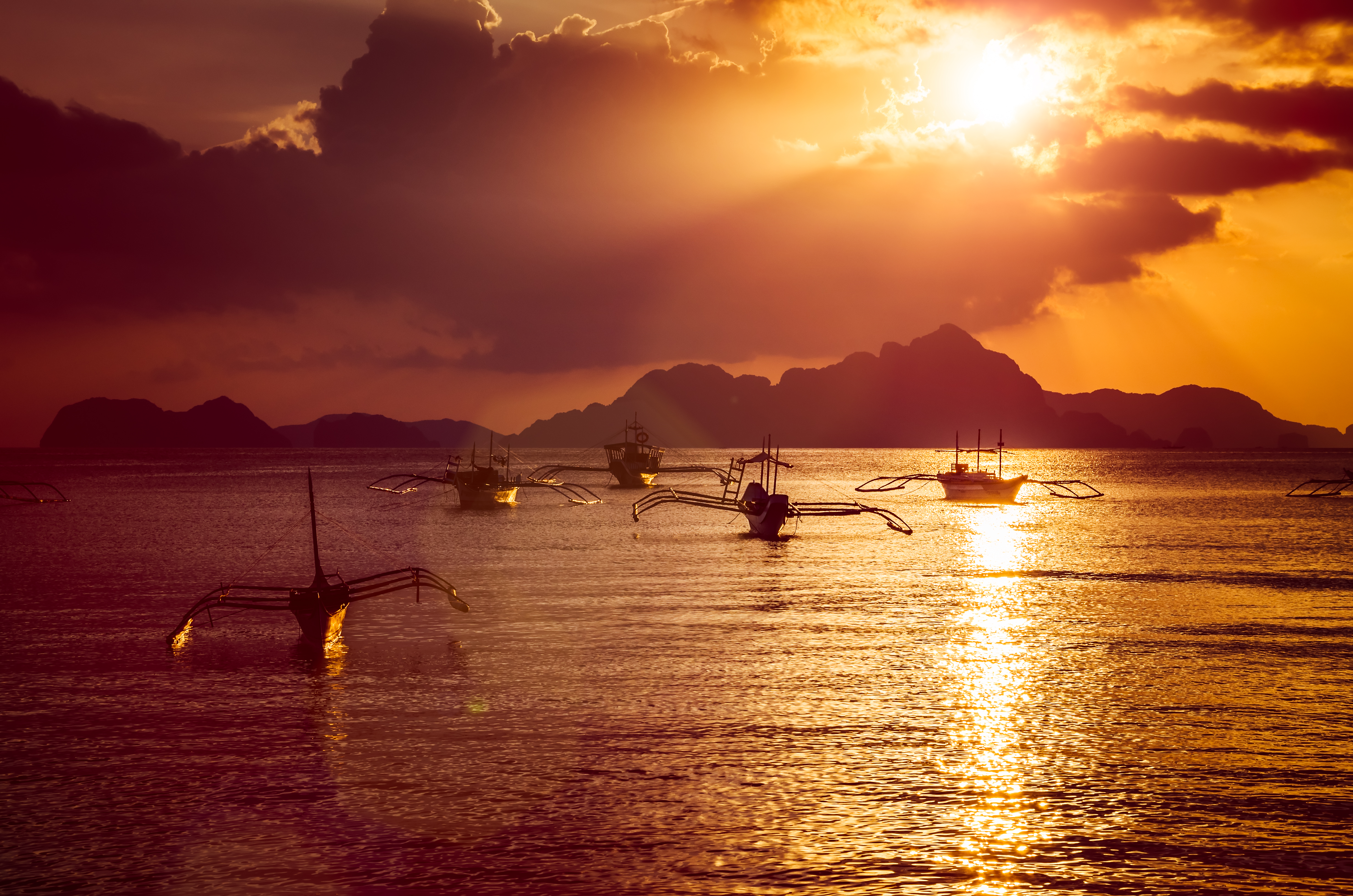Traditional filippino boats at El Nido bay in sunset lights. Palawan island, Philippines