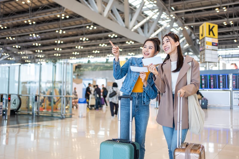 Asian young women passenger walk in airport terminal to boarding gate.s_kawee