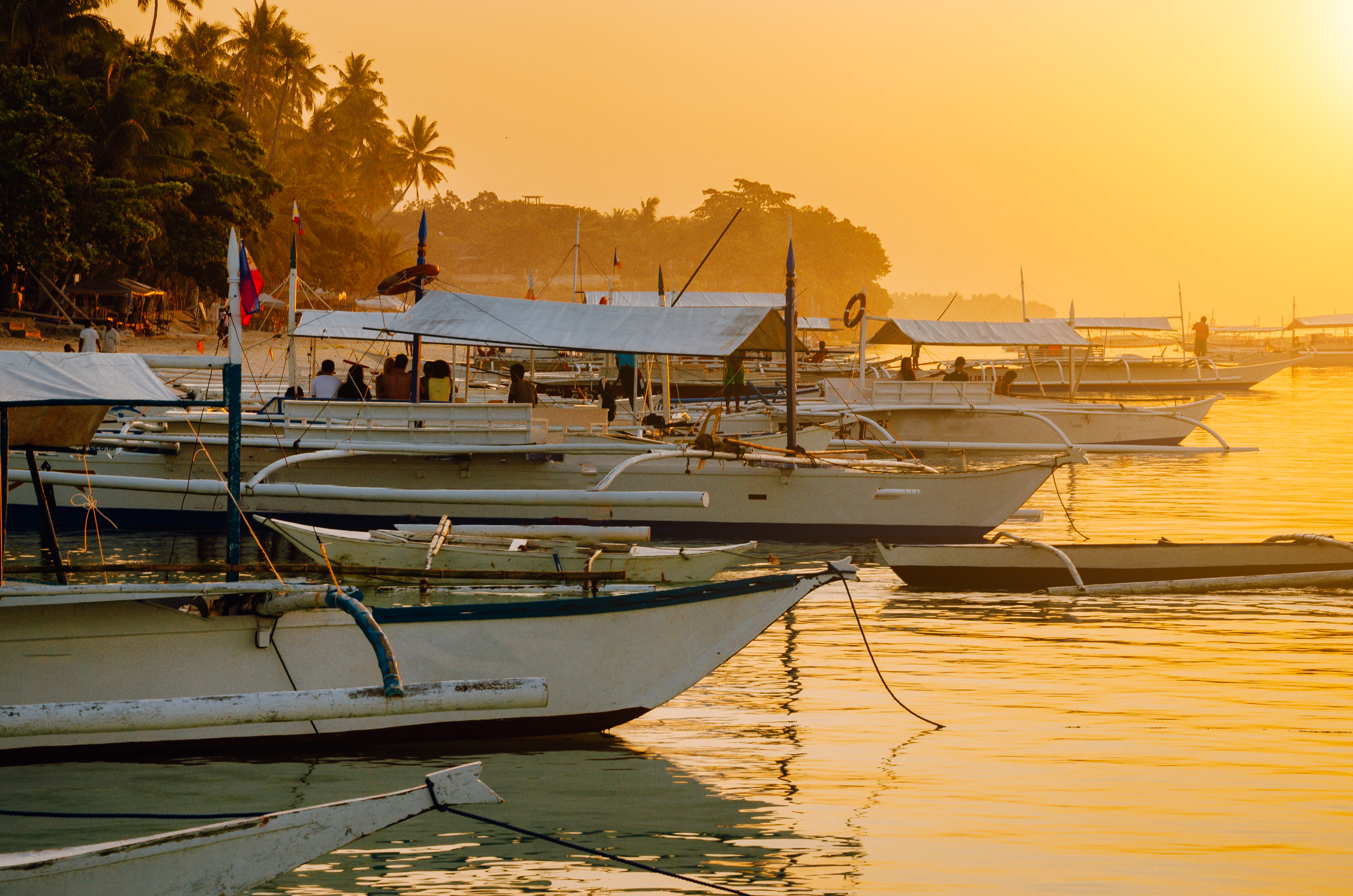 Sunset on the beach with silhouette of banca boat at Panglao Island, Bohol, Philippines