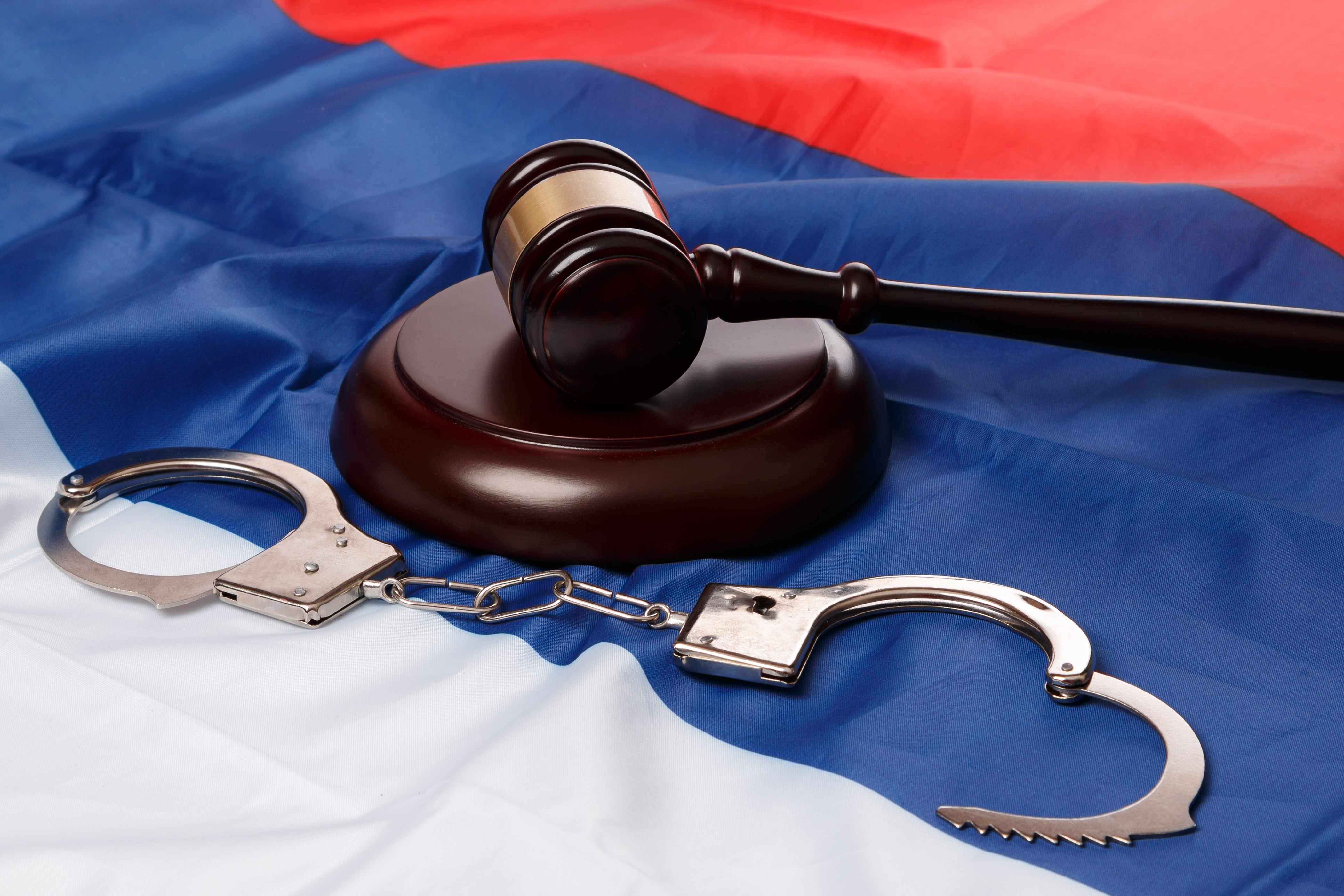 Gavel and Handcuffs on Flag