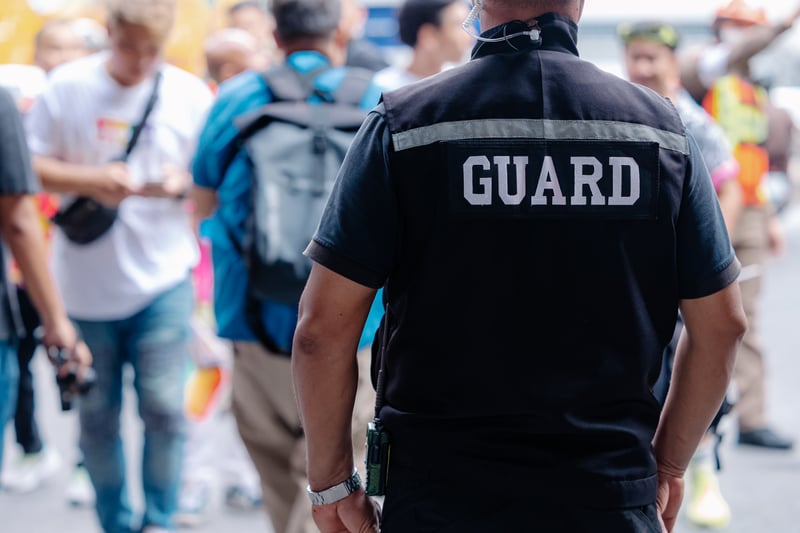 closeup security guard man in public area standing secure people or place outdoor.coffeekai