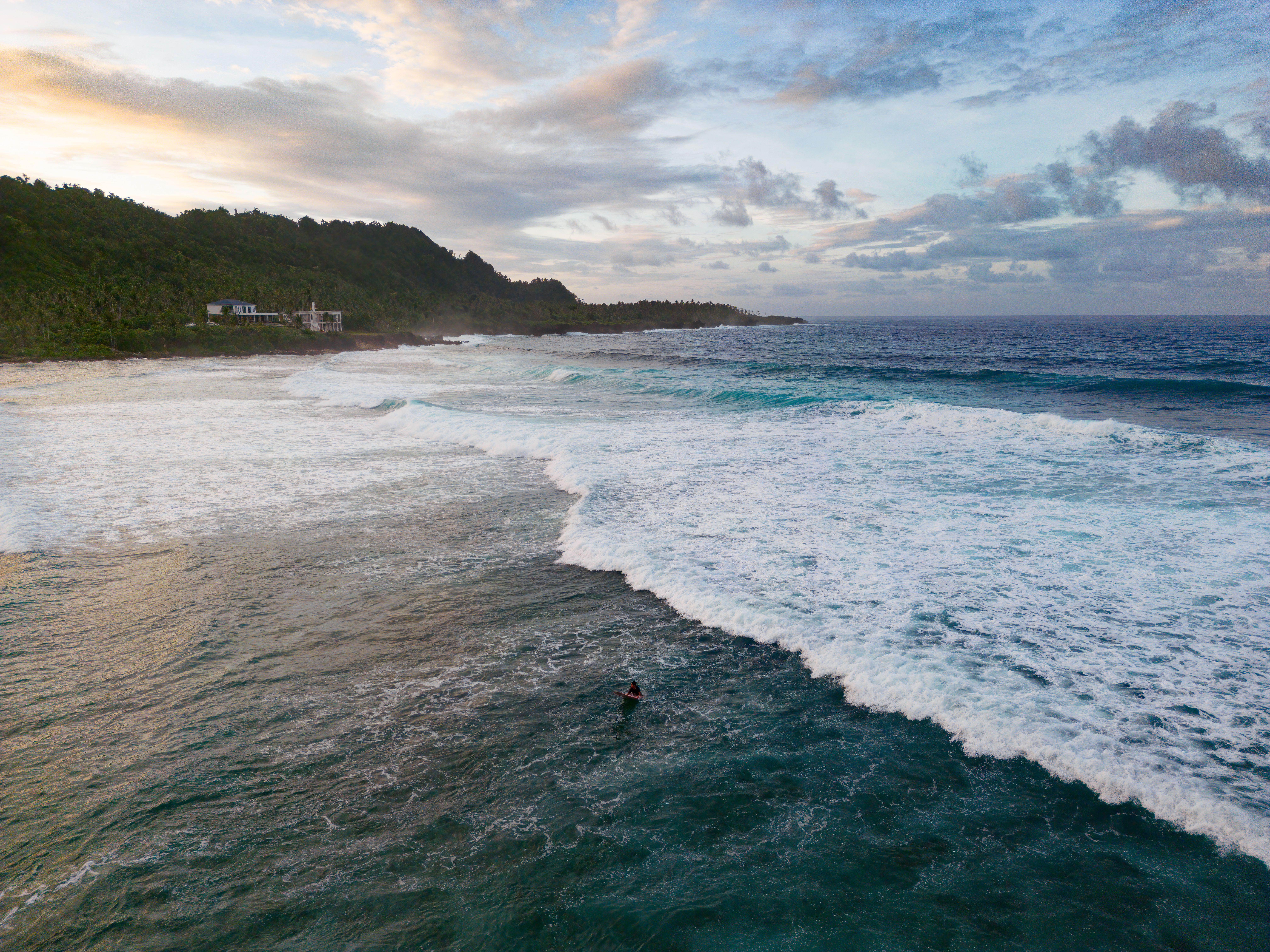 Aerial view of a surfer at Pacifico beach, Siargao, Philippines