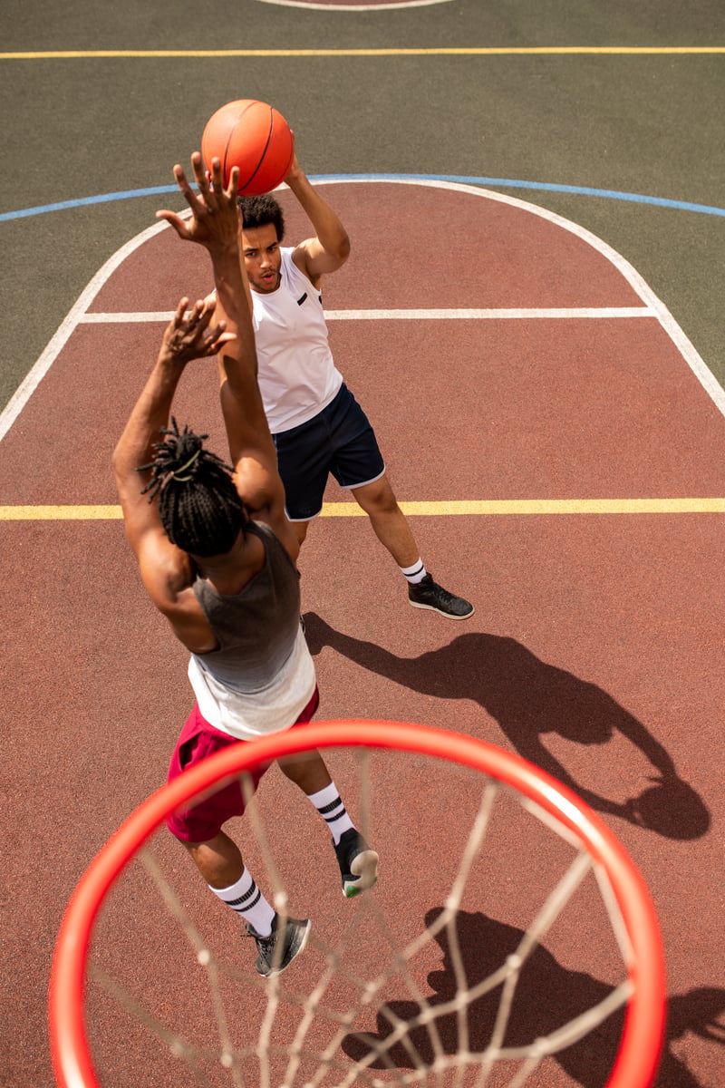 Two Men Playing Basketball on Outdoor CourtPressmaster