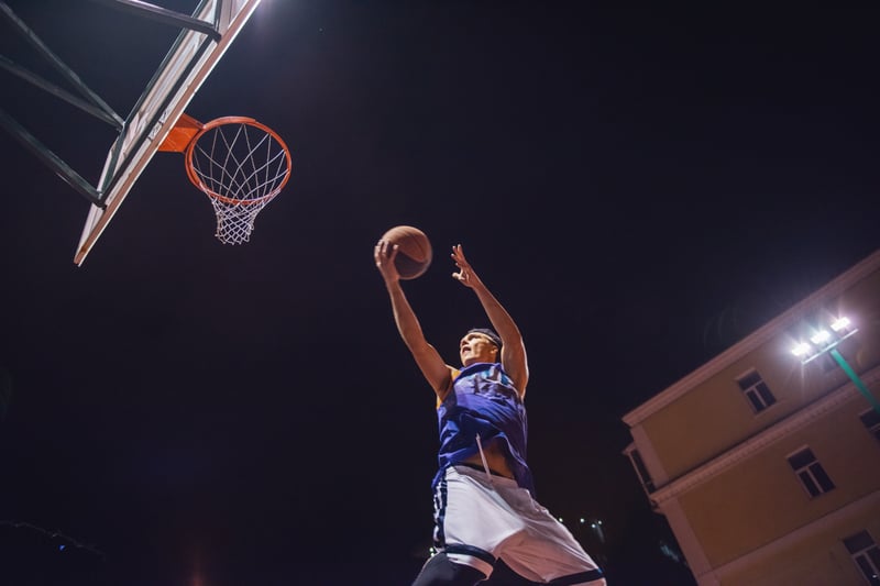 Basketball Player Jumping to Score During Night GameGeorgeRudy