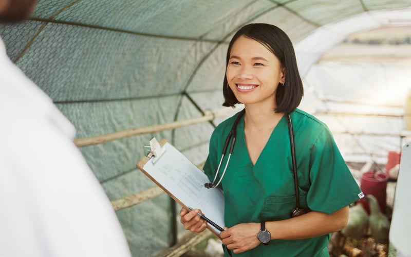 Vet, animal health and woman with checklist for bird flu symptoms and agriculture on chicken farm.YuriArcursPeopleimages
