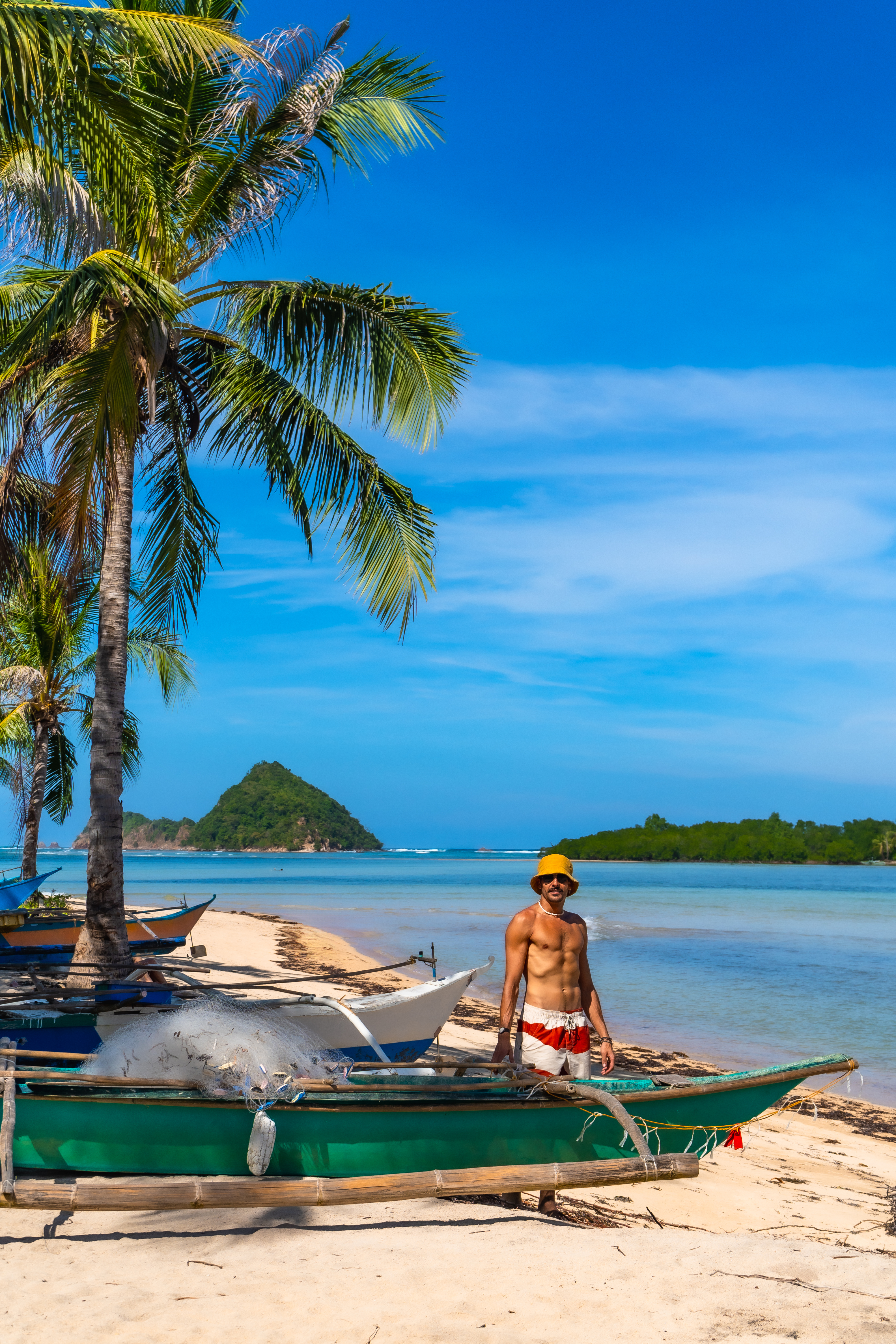 Fisherman working on lakdayan beach, coron island, philippines