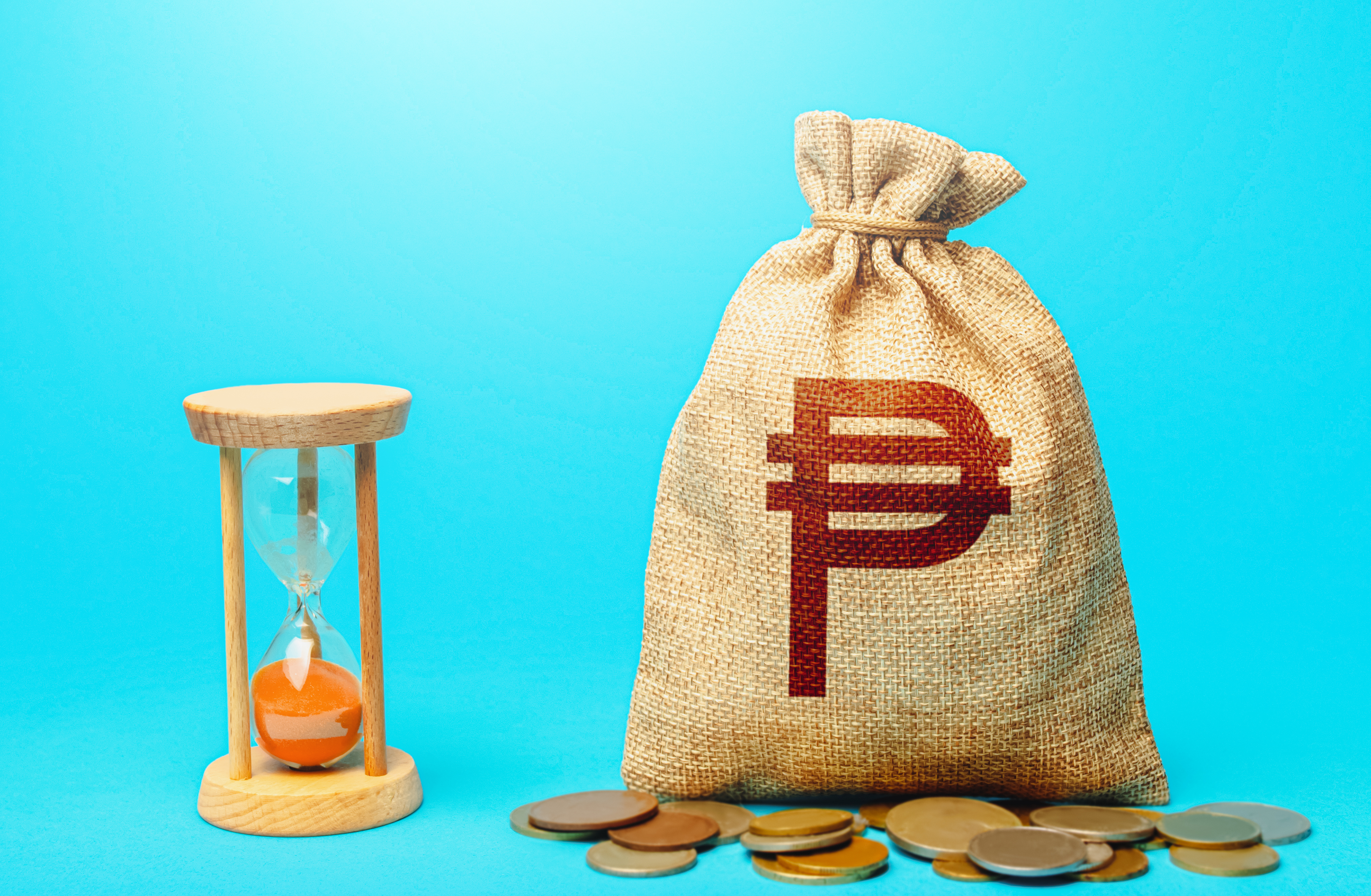 Philippine peso money bag and hourglass. Placing a deposit in the bank.