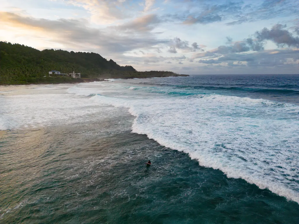 Aerial view of a surfer at Pacifico beach, Siargao, Philippines