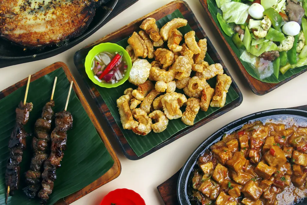 Assortment of Filipino Food Cuisine on Wooden Plates