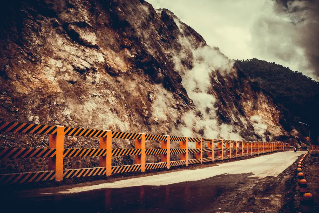 Captivating view of a mist-covered road along a mountainside in Dumaguete, Philippines.